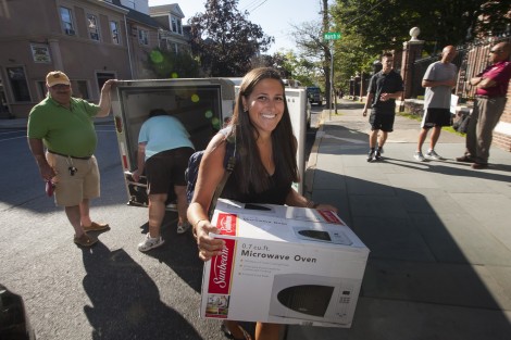 A new student unloads the U-Haul trailer.