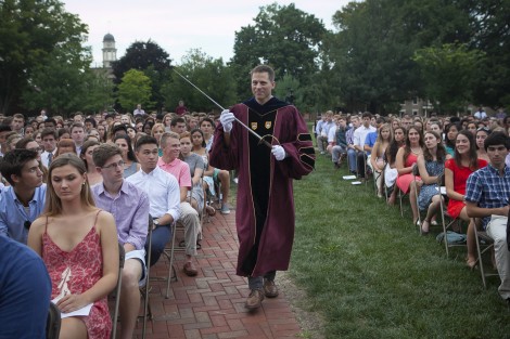 As part of College tradition, Paul McLoughlin, dean of students, presents the sword of the Marquis de Lafayette to the incoming class.