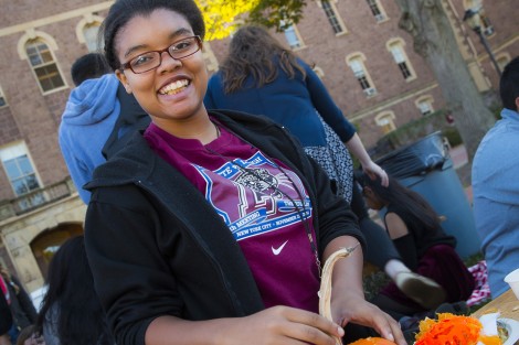 Karyn Wood ’19 finishes cleaning the insides out of her pumpkin.
