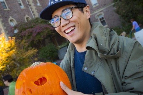 Leo Zhu ’17 has some fun with his pumpkin.