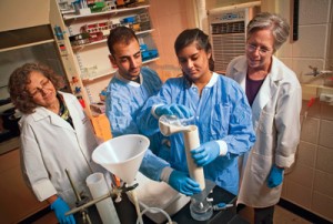 Prof. Laurie Caslake (L-R), Michael Galperin ’16, Jasmeen Saini ’16, and Prof. Mary Roth investigate biofilms formed by bacteria in sandy soil.