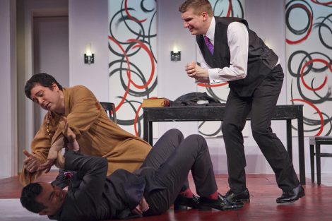 Two students act on stage in a scene from the Lafayette production of the play Tartuffe.