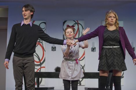 Three students act on stage in a scene from the Lafayette production of the play Tartuffe.