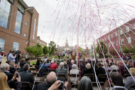 Confetti streams toward those seated the groundbreaking ceremony.