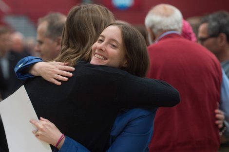 Two women hug after the Baccalaureate service.