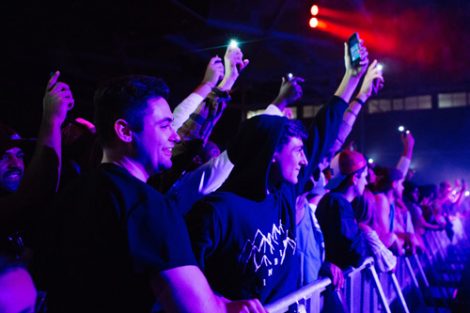 Students hold up their cell phones at the Spring Concert.