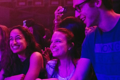 Two female and one male student smile at the Spring Concert.