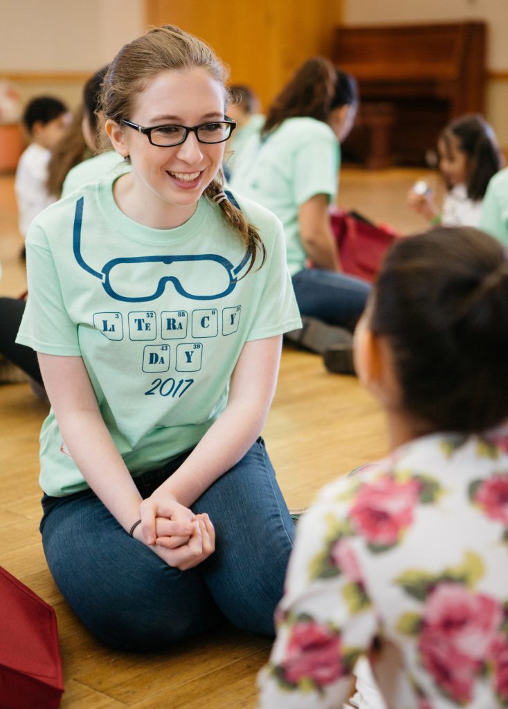Erin McKenney '20 speaks with girl on Literacy Day.