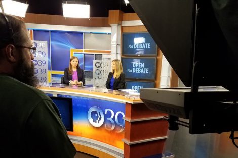 Hannah Doherty ’19 and Natalie Gosnell '18, the two anchors for the Open for Debate, sit at the anchor desk