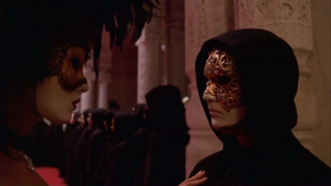A man and a woman each wear a mask in the film Eyes Wide Shut.