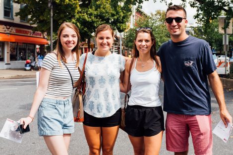 Four students smile for a photo downtown