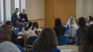 Chip Bergh '79 speaks to students while Yusuf Dahl looks on.