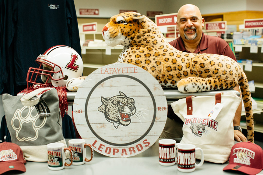 Chuck Corsi with merchandise in the College Store