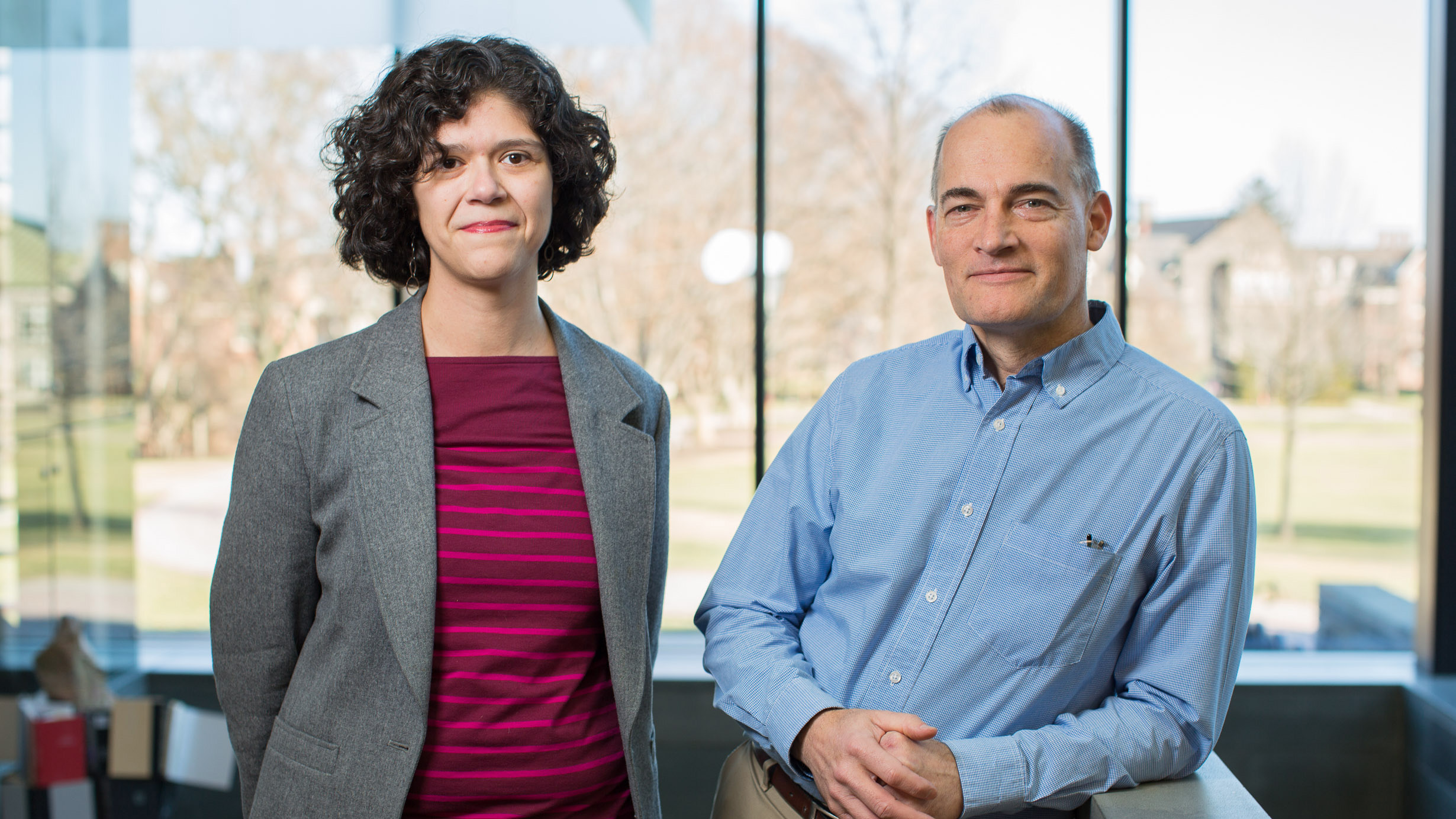 Anna Luhrs and James DeVault standing in the library