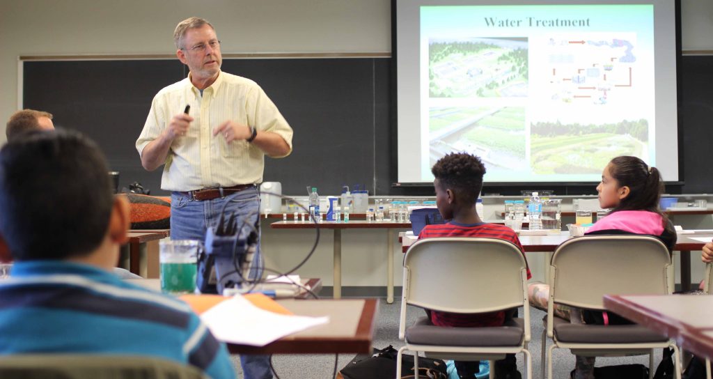 Professor Art Kney teaches at the front of the classroom.