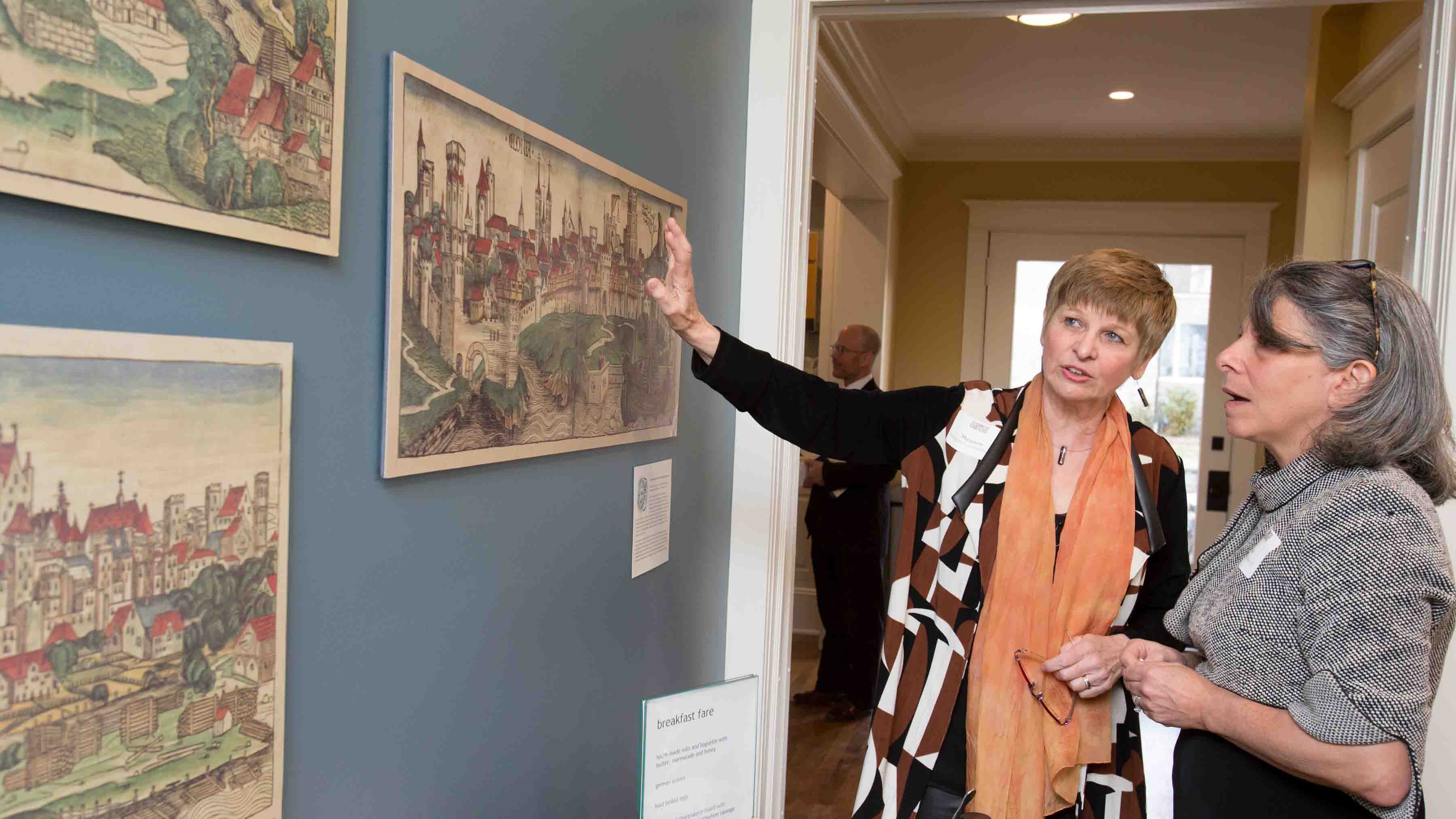 Margarete Lamb-Faffelberger and Leslie Muhlfelder look at art during the dedication of the Max Kade Center for German Studies and Visiting Scholars