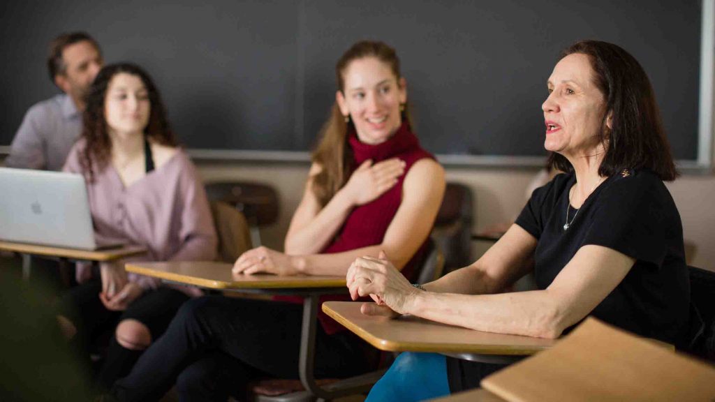 Students listen to a member of Pascal Rioult's dance troupe in class.