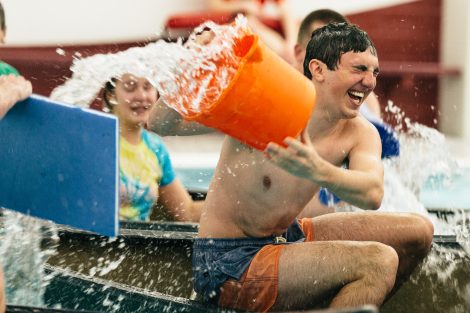 Students try to flood and sink other canoes in the Battleship game in Weinstein Natatorium.