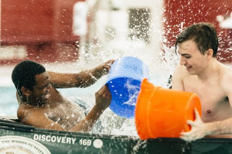 Students try to flood and sink other canoes in the Battleship game in Weinstein Natatorium.