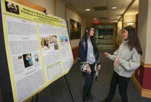 A student talks to another student in front of a poster at the LVAIC Sustainability Conference hosted by Lafayette College.