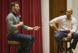 Justin Kamine '11 and Yusuf Dahl talk on stage at Colton Chapel.