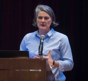 Kira Lawrence, Professor and chair of geology and environmental geosciences, talks at the lecturn.