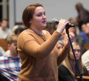 A student at the microphone ask Stephen Pacala a question after his lecture about climate change in Lafayette College's Colton Chapel.