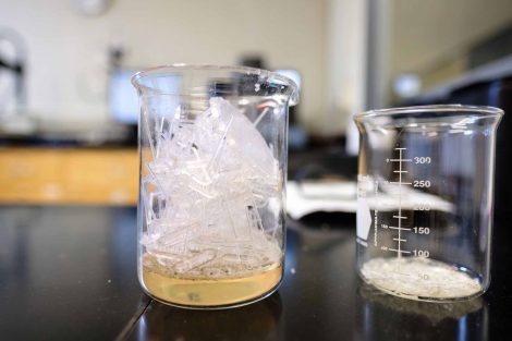 Scraps from 3D printing in a glass jar next to another glass jar