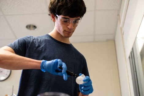 A student works on an item made with the 3D printer.
