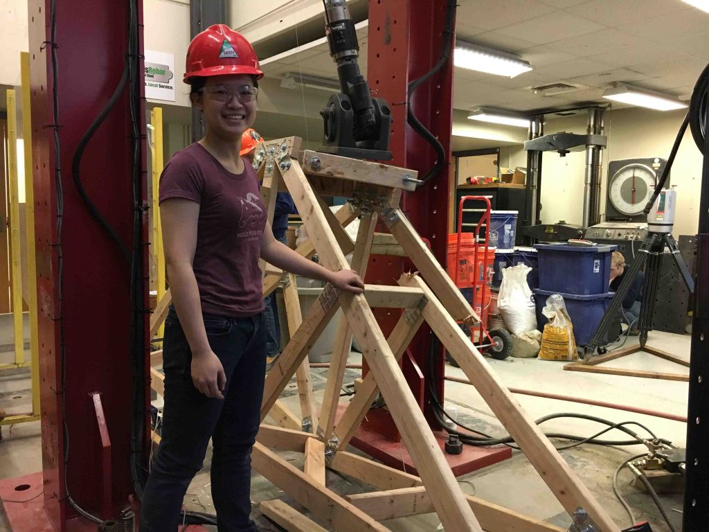 Monica Meng '18 stands by the Maroon Monster hydraulic press.
