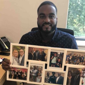 Carlos Tavares holds a set of photos representative of communities that have been invaluable to him.