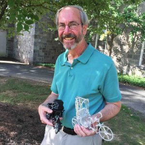 Steven Swidler holds gifts from his former students.
