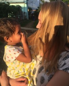 Thea Dekker holds a toddler