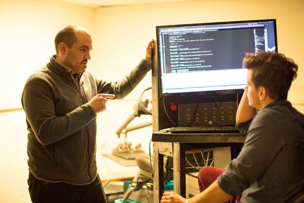 Professor Alex Brown talks with one of his research students.