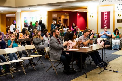 The judges and audience watch the lip sync and air band contest.