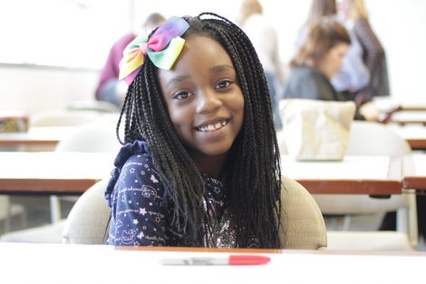 A child smiles in the classroom where Lafayette students from the First-Year Seminar Happiness class interacted with school children.