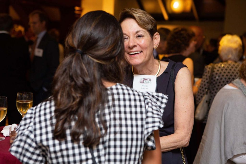 Diane Cole Ahl speaks with someone at an alumni event at the Metropolitan Museum of Art.