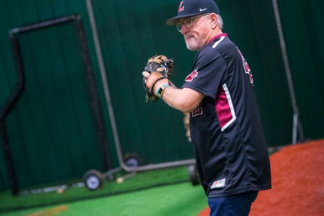 Chicago Cubs manager Joe Maddon gets ready to throw a baseball.