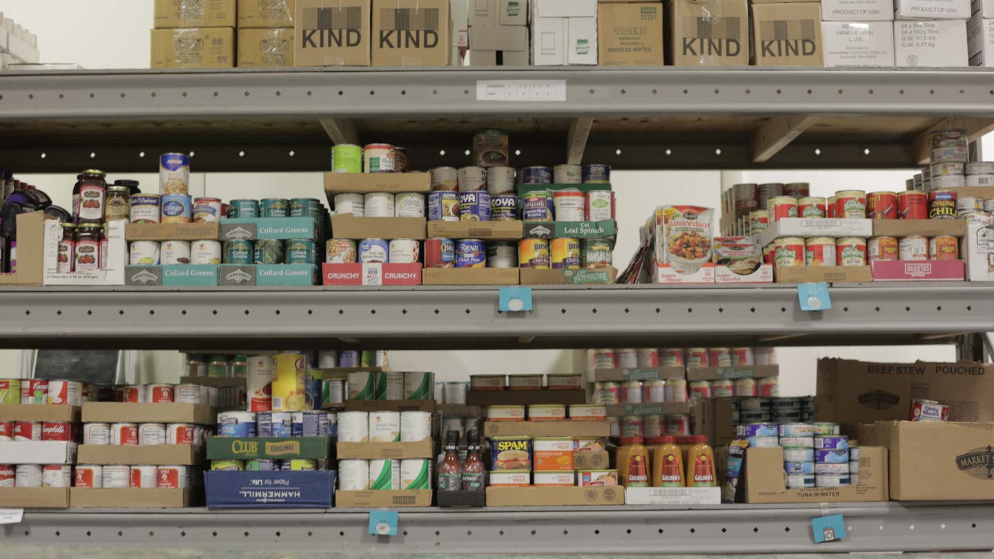 Shelves of canned and packaged goods at a food pantry