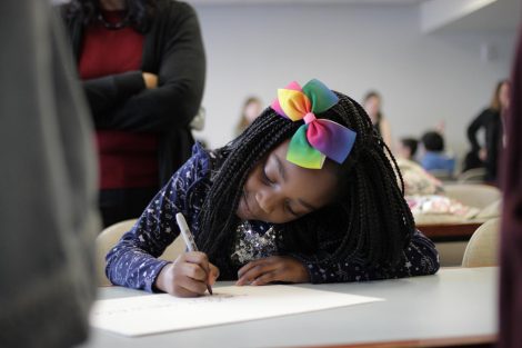 School children use magic markers during the session led by Lafayette College students in the Happiness First-Year Seminar.
