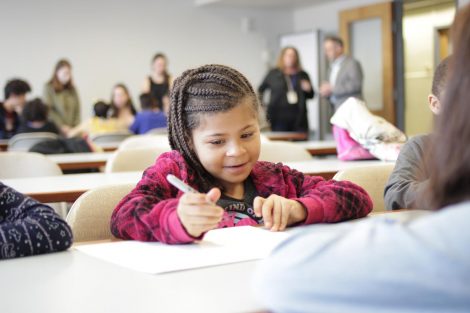 School children use magic markers during the session led by Lafayette College students in the Happiness First-Year Seminar.