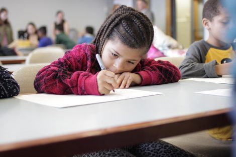 School children use magic markers during the session led by Lafayette College students in the Happiness First-Year Seminar.