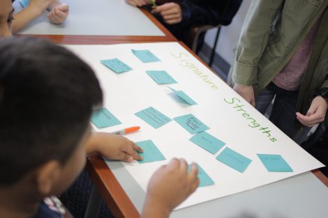 School children write on Post-It Notes during the class section led by Lafayette's Happiness First-Year Seminar.