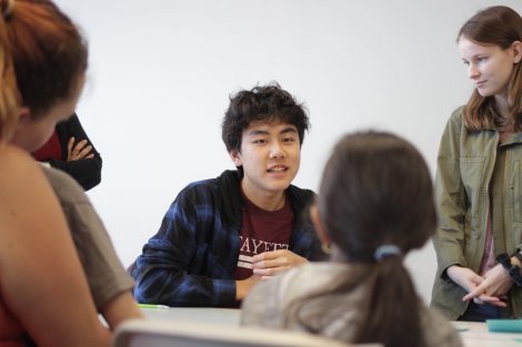 School children write on Post-It Notes during the class section led by Lafayette's Happiness First-Year Seminar.