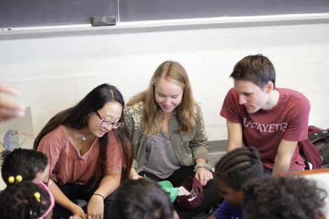 Lafayette students from the First-Year Seminar Happiness class interact with school children.