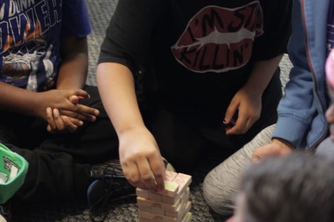 School children play the game jenga.