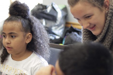 Lafayette student working one-on-one with elementary students.