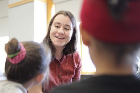Lafayette student working one-on-one with elementary students.