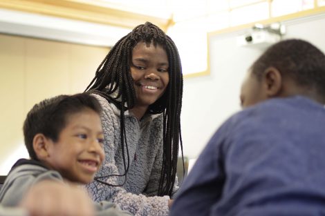 Lafayette student working one-on-one with elementary students.