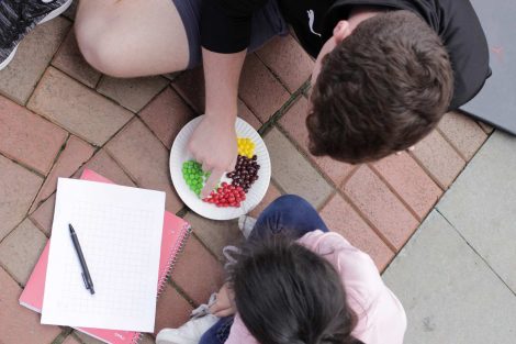 A Lafayette College student and Cheston Elementary School third-grader learn math by using Skittles during a Center for Community Engagement program.